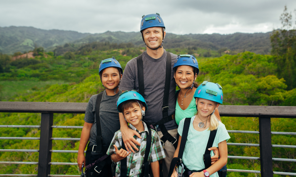 family zip-lining while on vacation on Oahu