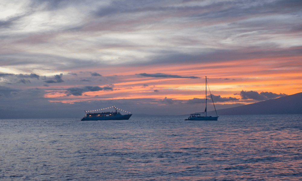 2 boats on the water on a sunset cruise in hawaii