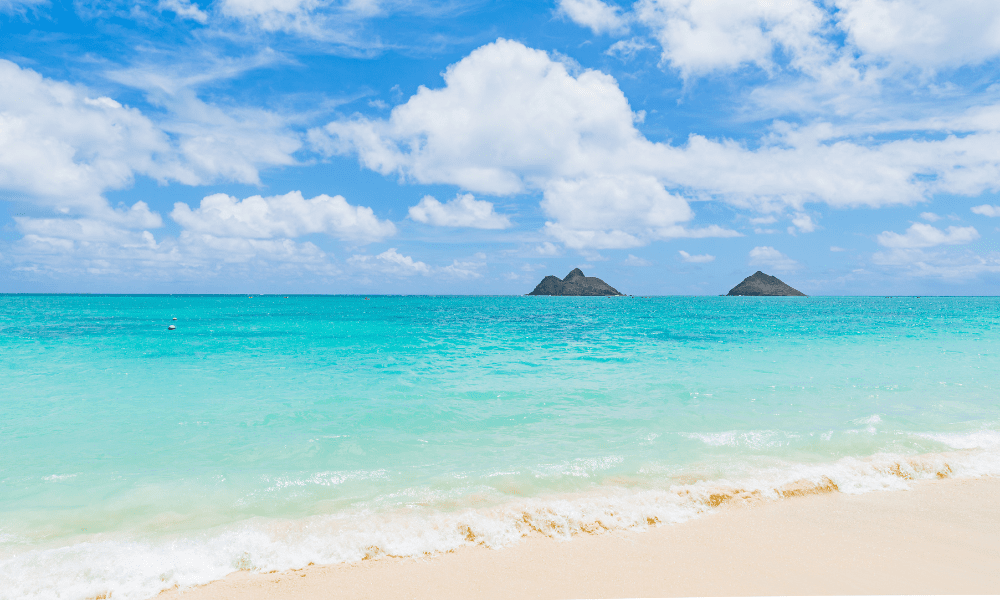 turqoise waters at kailua beach on Oahu; two islands are in the distance